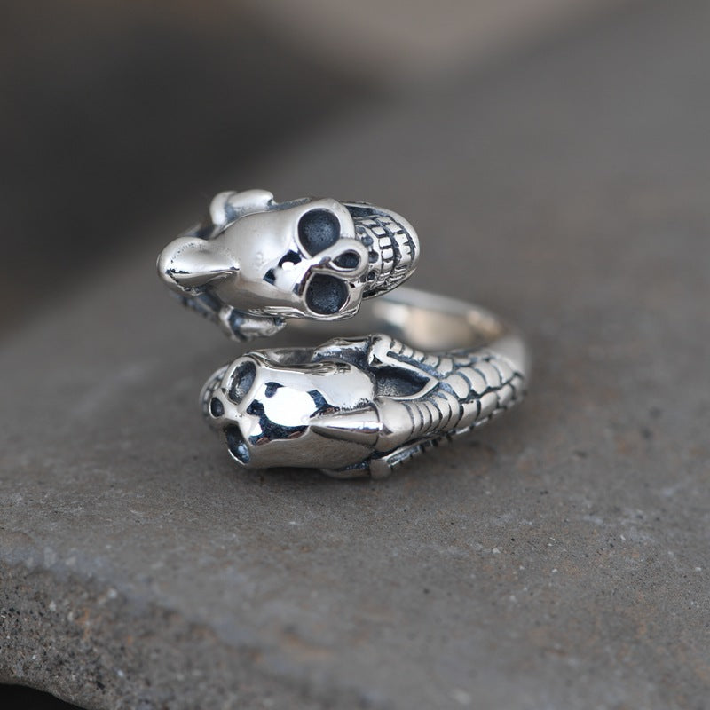 Gothic double skull and claw ring angled view showing twin skulls and textured claw details