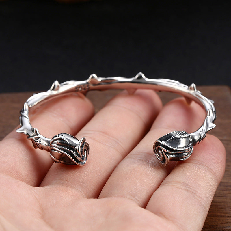 S925 sterling silver rose bracelet held in hand showing 58mm diameter and vintage floral bangle design