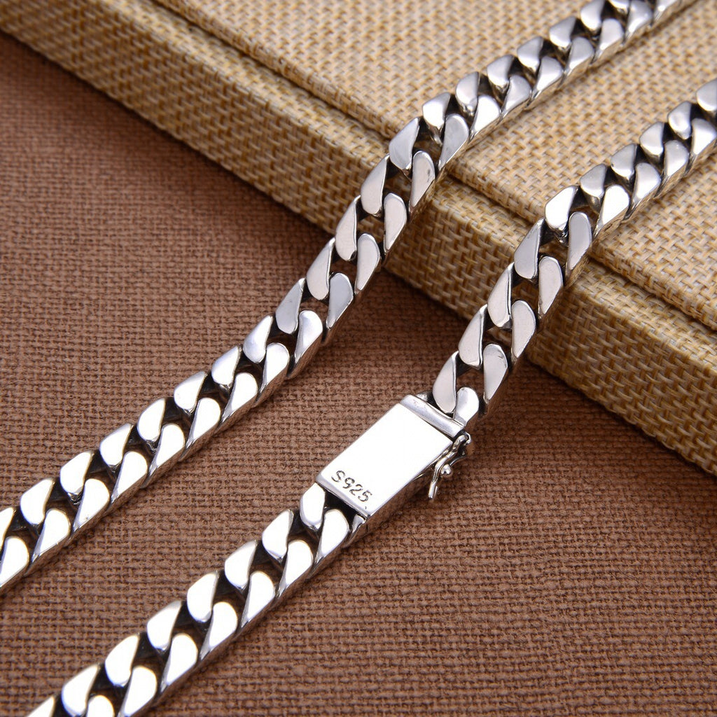 S925 sterling silver 7mm Cuban links close-up showing beveled edges dimensional detail and Thai silver patina
