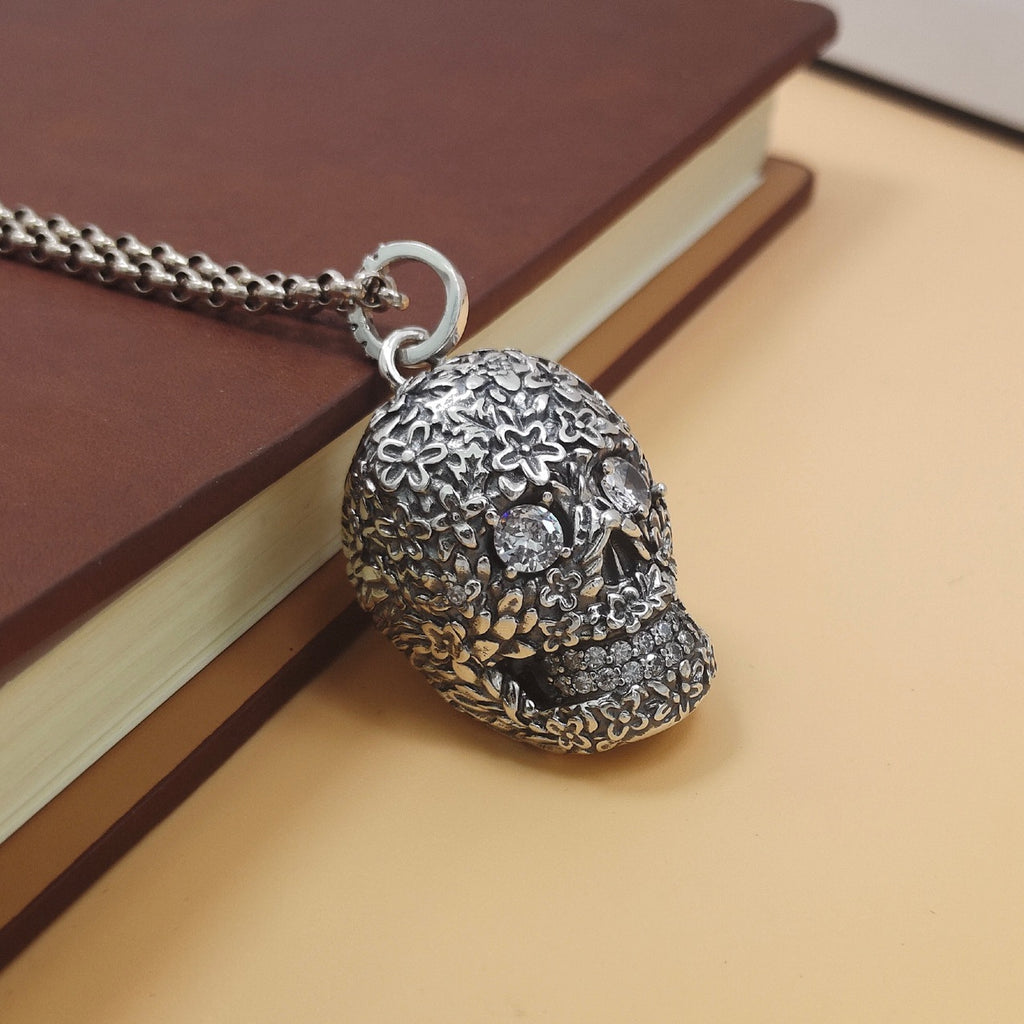 S925 sterling silver baroque skull pendant on book showing dimensional floral texture, zircon stones and antiqued patina