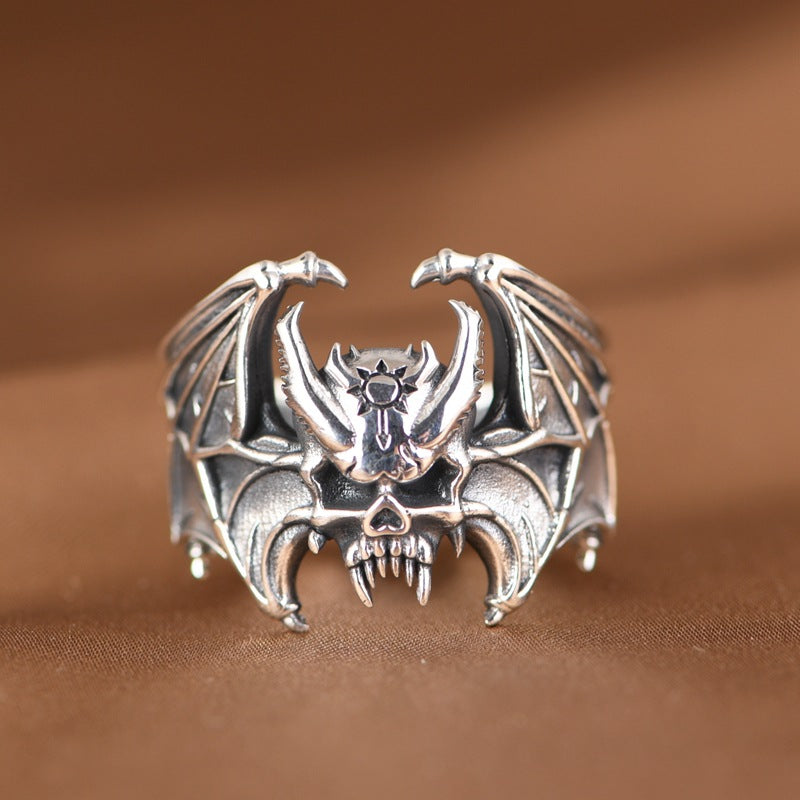 Front view of S925 sterling silver bat skull ring worn on finger showing gothic bat skull spread wings and bold statement design
