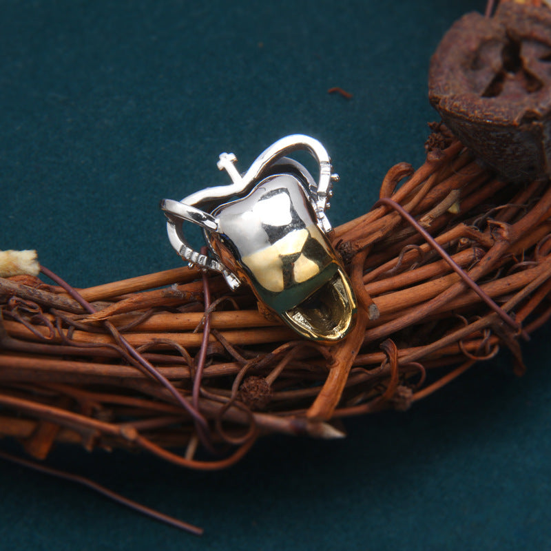 Back view of S925 sterling silver crown skull pendant with brass skull on rope showing Thai silver craftsmanship