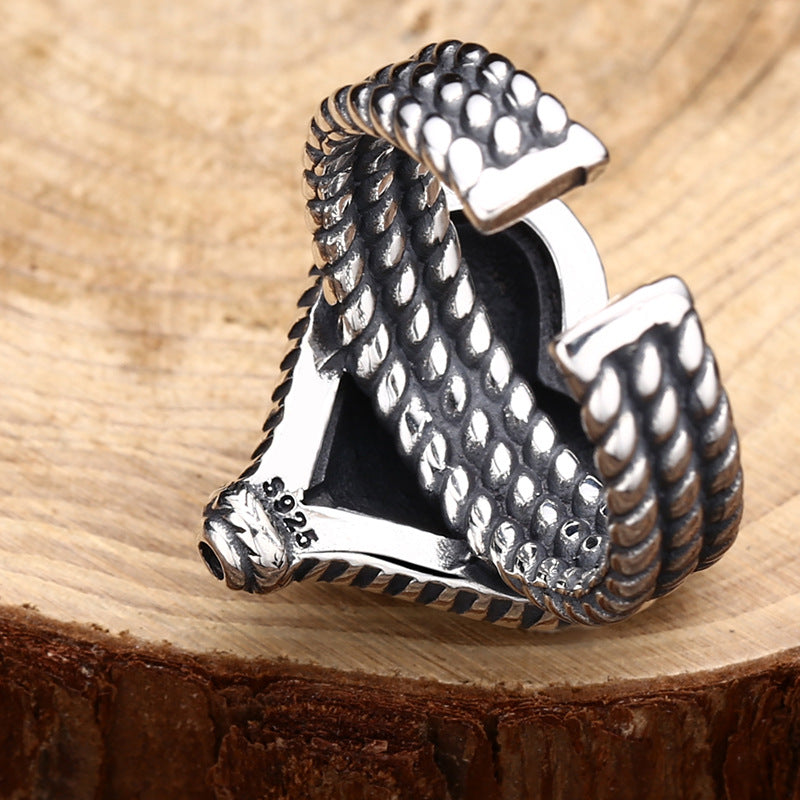 S925 sterling silver heart ring on wood showing textured adjustable band and dimensional heart charm