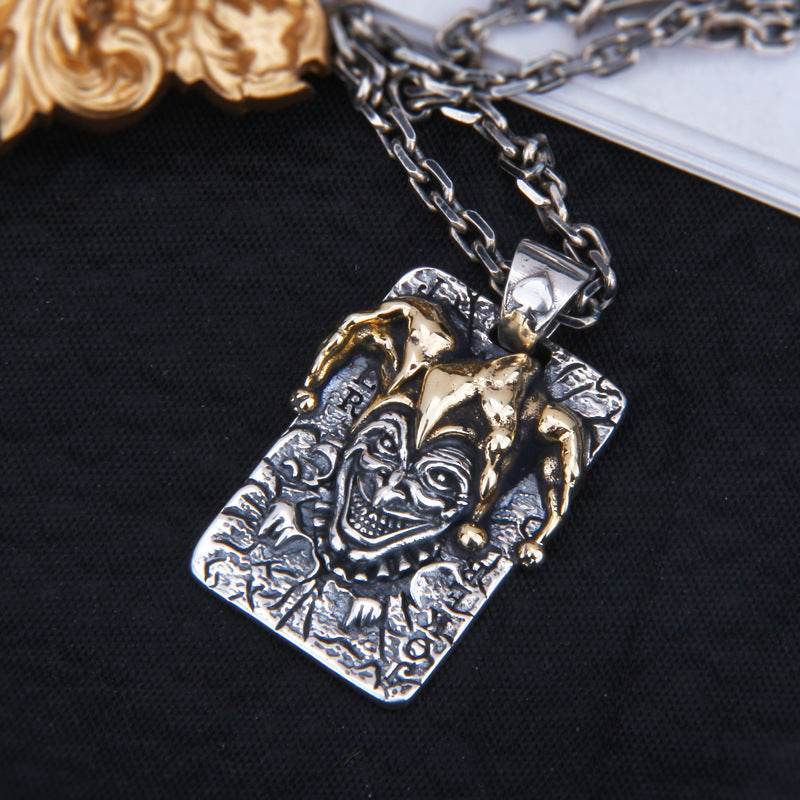 Angled view of S925 sterling silver joker pendant on chain showing brass accents gothic joker design and dimensional detail