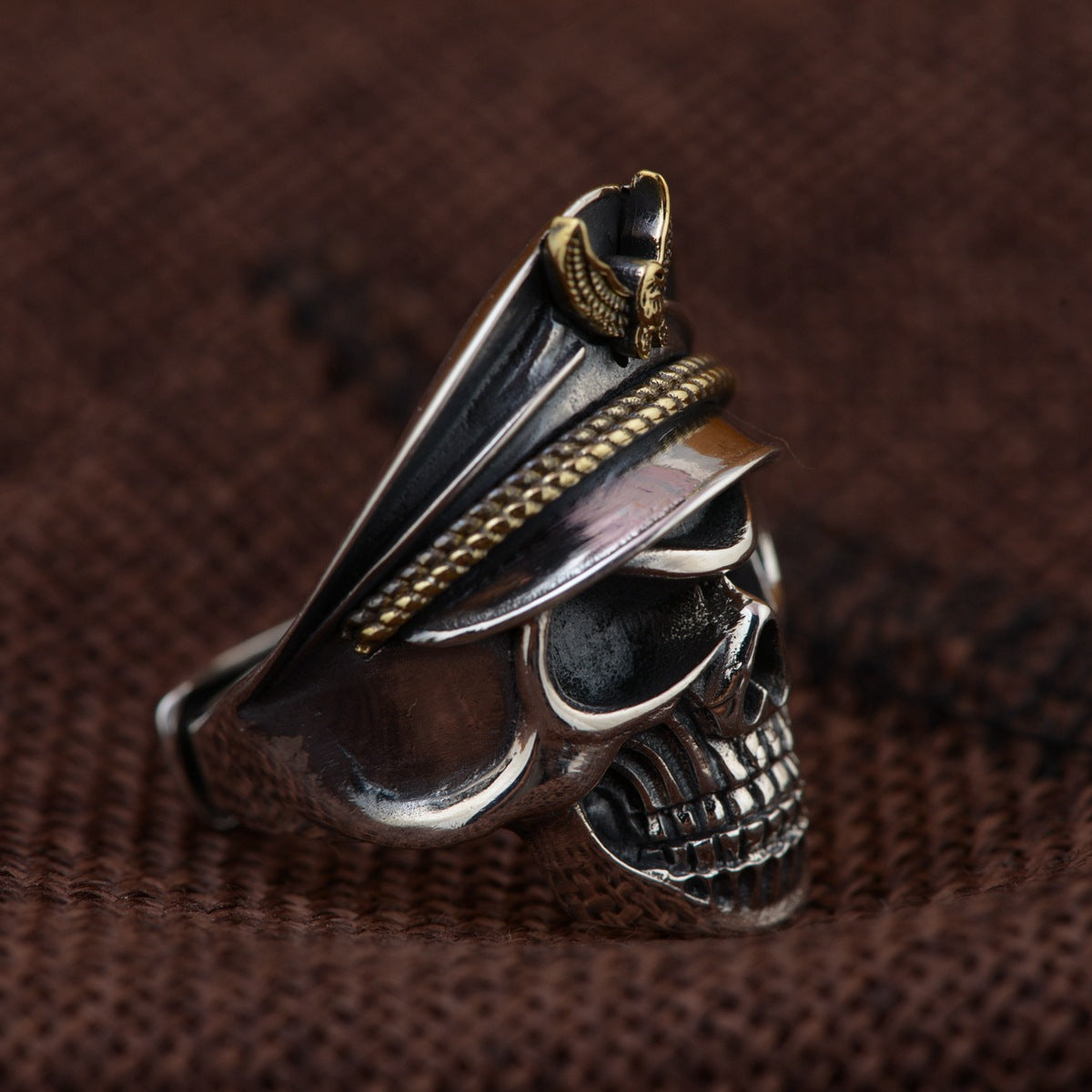 Side profile of S925 sterling silver officer skull ring on wood showing military cap gold eagle emblem and adjustable band