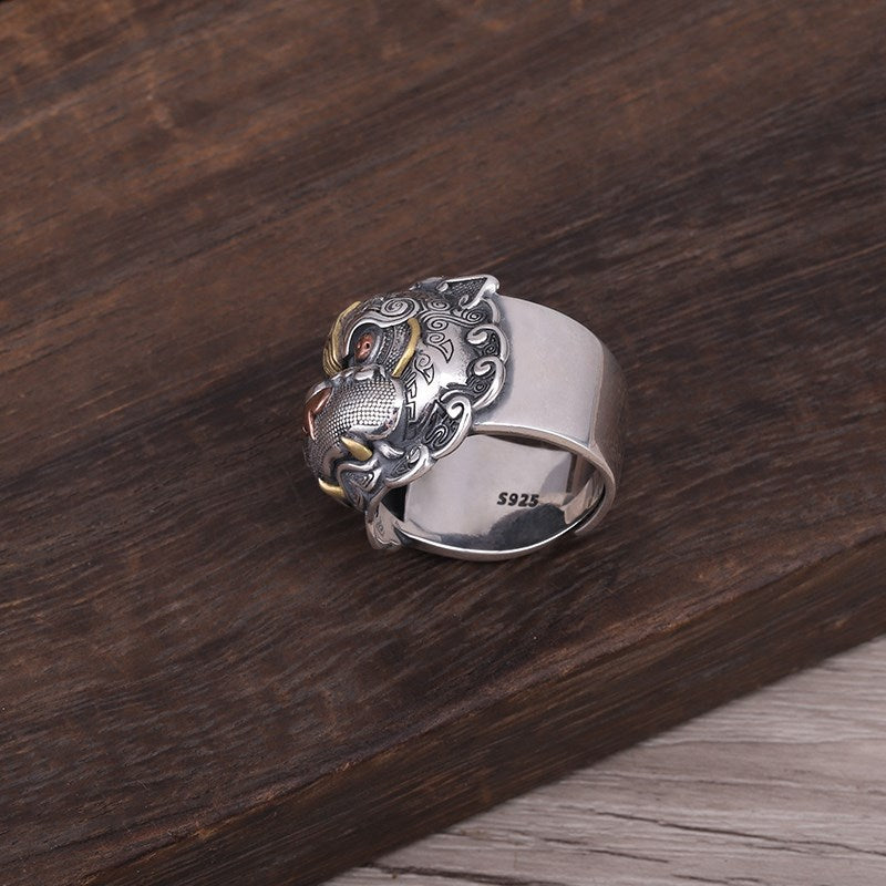 S925 Pixiu ring on dark wood surface showing adjustable band, dimensional detail and oxidized finish