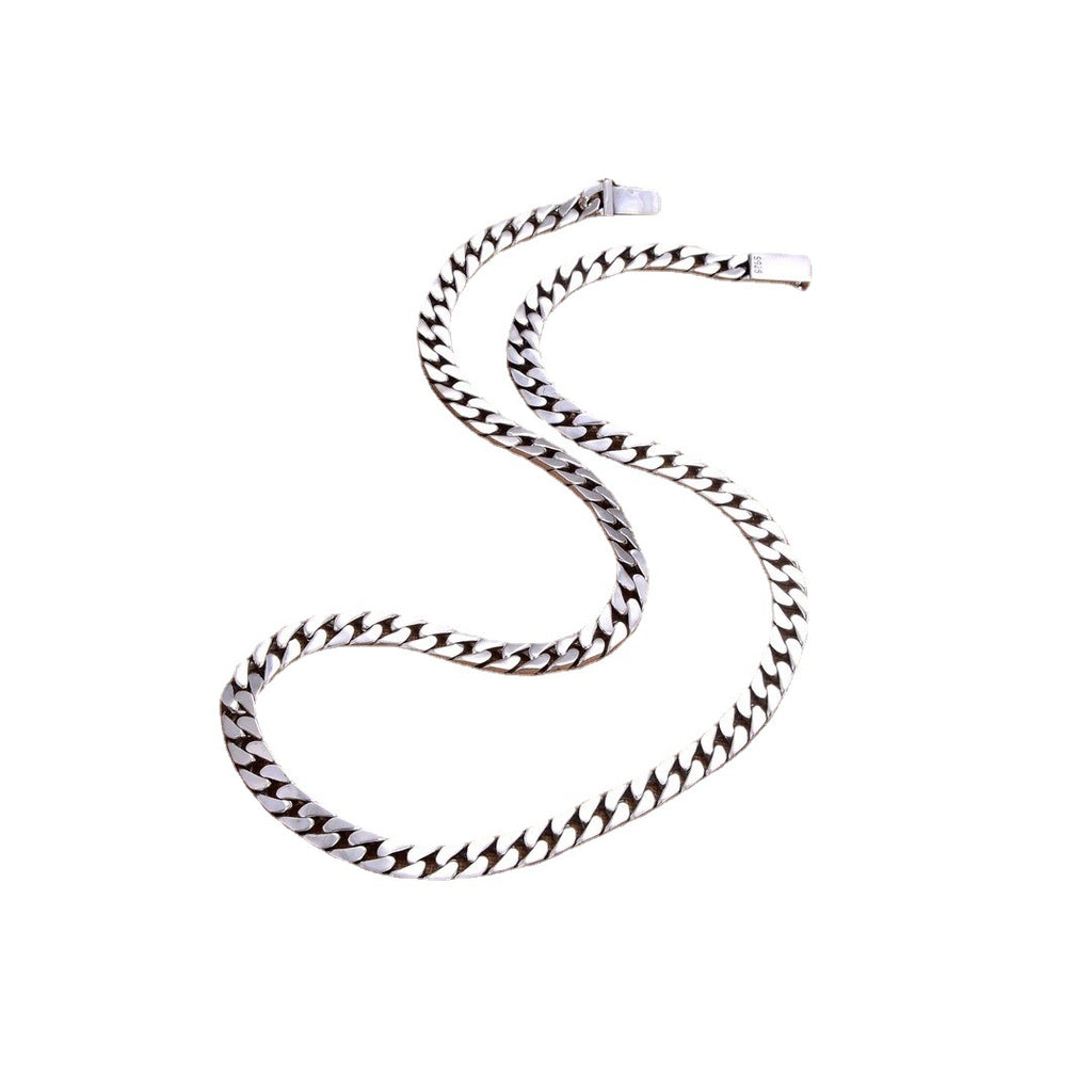 S925 sterling silver Cuban link chain on white background showing oxidized Thai silver finish and dimensional links