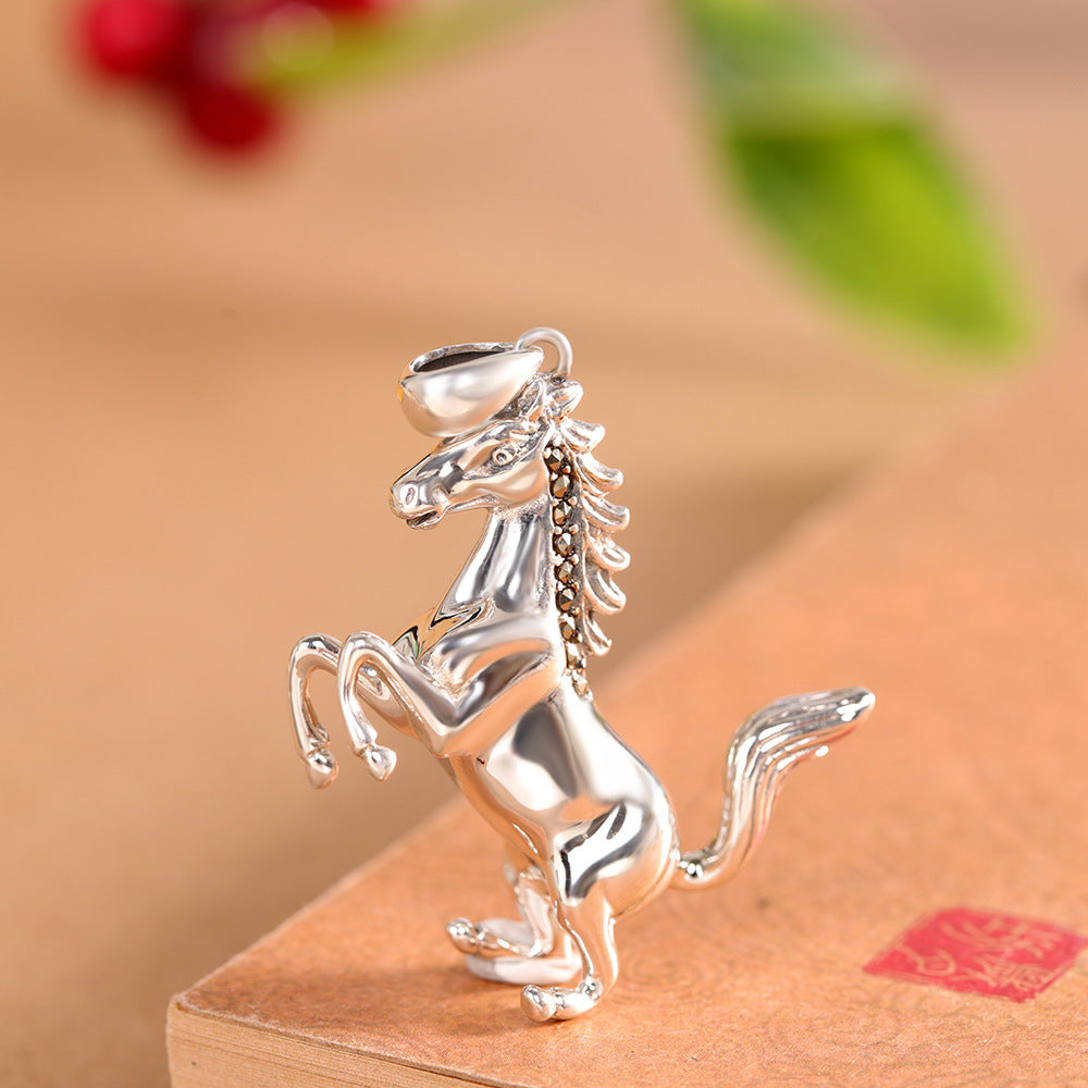 S925 sterling silver rearing horse pendant on warm background showing dramatic stance, detailed mane and premium finish