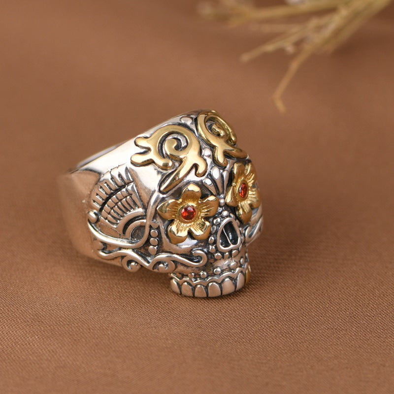 S925 sterling silver sugar skull ring on wood surface showing dimensional relief, copper flower details and gothic craftsmanship