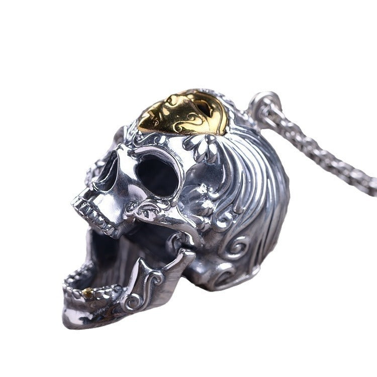 Angled view of an S925 Thai silver skull pendant featuring ornate carved swirls and a contrasting gold-toned crown top.