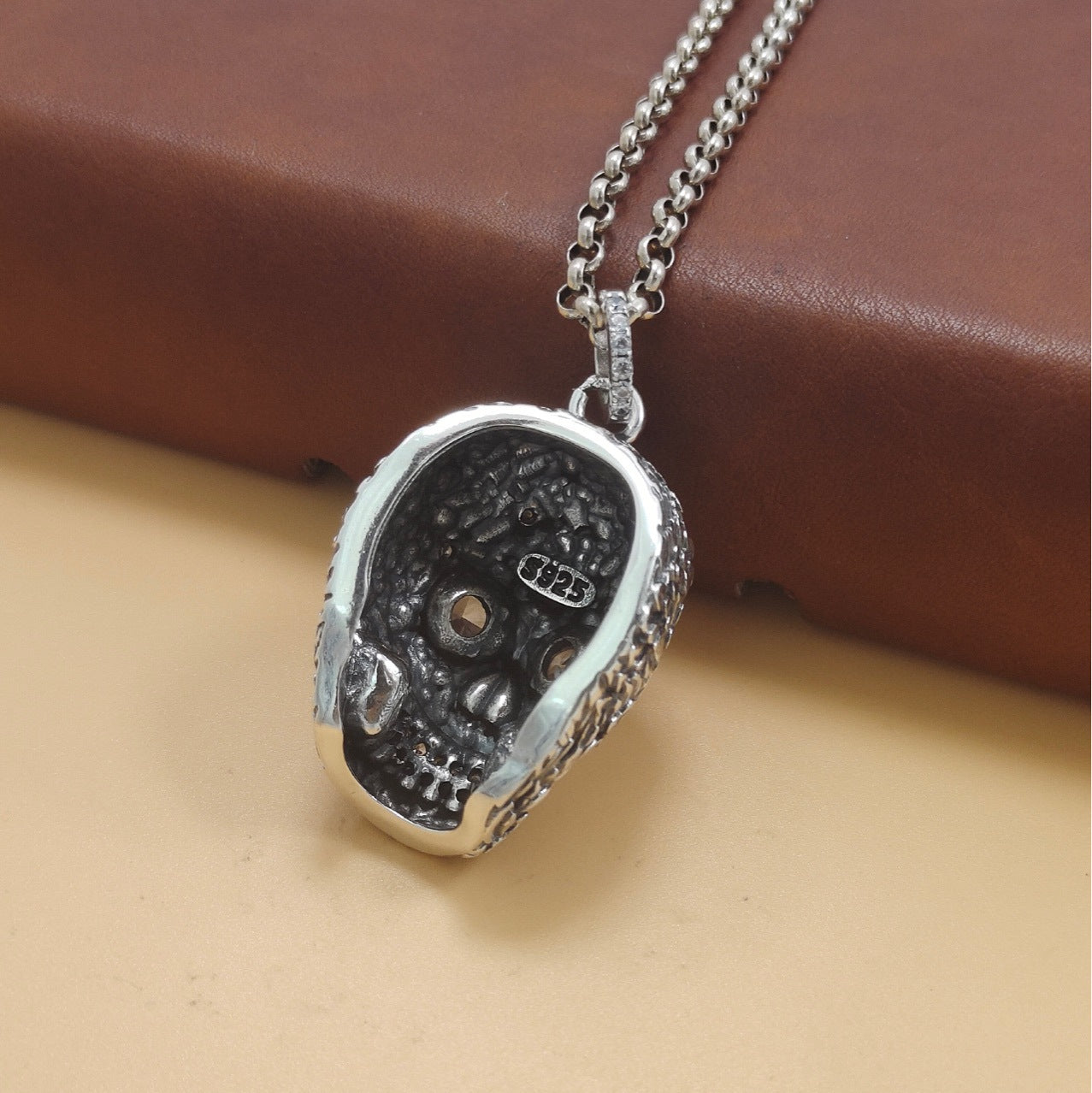 S925 sterling silver baroque skull pendant back view on chain showing hollow construction and detailed floral engraving