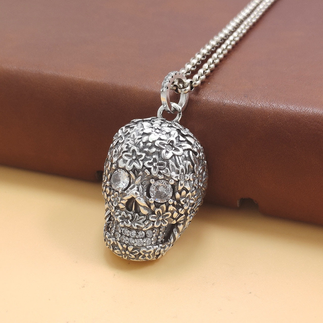 S925 sterling silver baroque skull pendant on chain showing ornate floral relief, crystal details and wearable scale