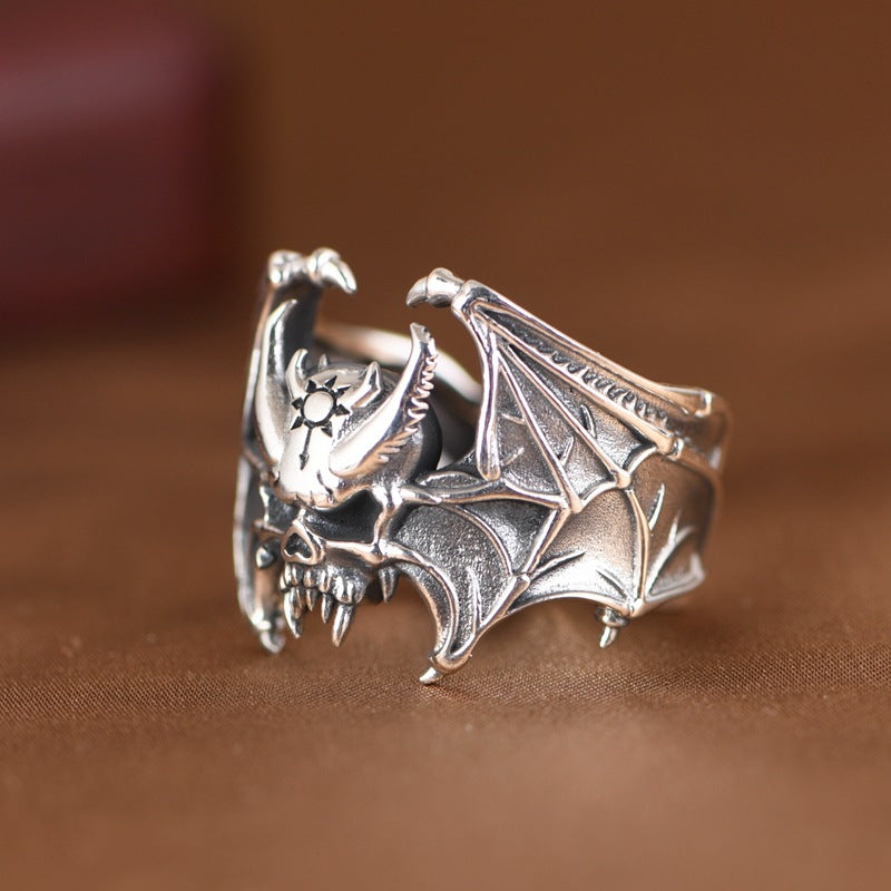 S925 sterling silver bat skull ring worn on finger showing gothic bat wings spread design and dimensional detail