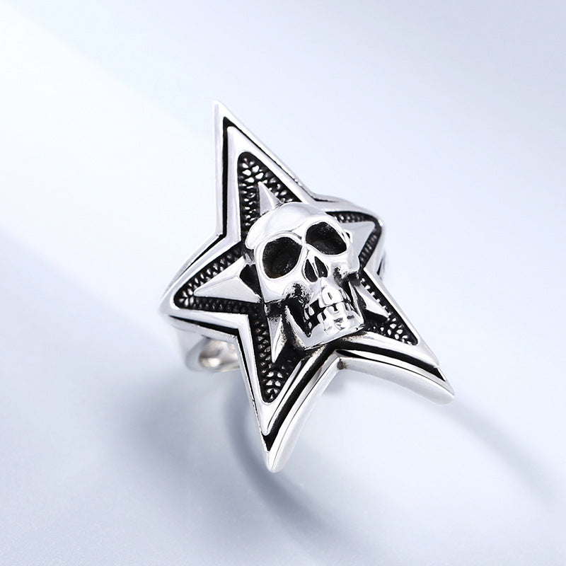 Angled view of S925 sterling silver five-pointed star skull ring on light surface showing pentagram skull detail and occult symbolism