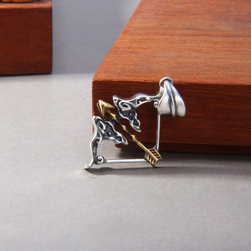 S925 sterling silver medieval archer bow arrow pendant on surface showing brass arrow detail medieval archery symbolism and dimensional craftsmanship