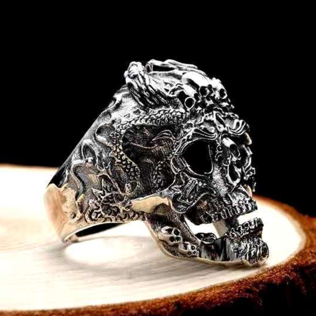 Sterling silver necromancer skull ring on wood surface showing detailed Gothic crown, dimensional skull relief and intricate ornamentation