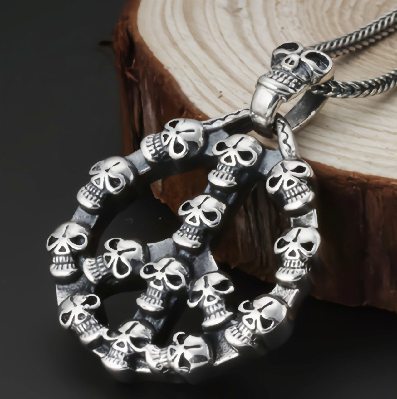 S925 sterling silver peace skull pendant on natural shell showing multiple skull elements, chain attachment and gothic craftsmanship