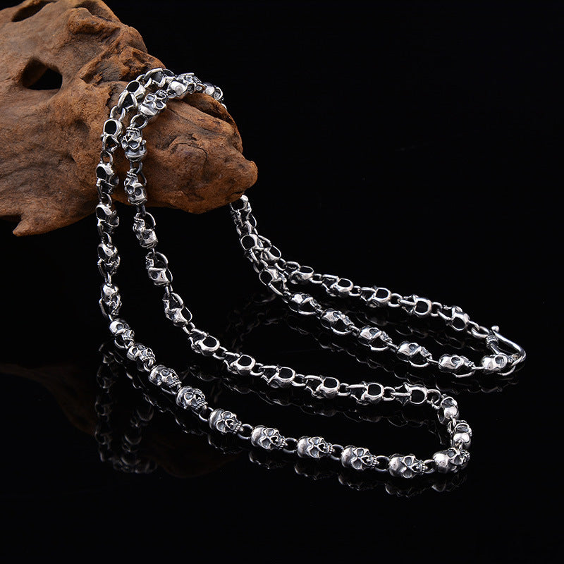 S925 sterling silver skull chain necklace 6mm held in hand on wood showing bold link design and substantial weight