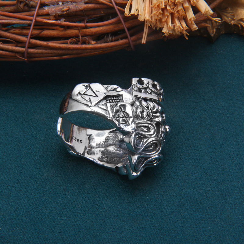 Sterling silver Gothic skull king ring interior view on teal surface showing adjustable open band design and S925 stamp