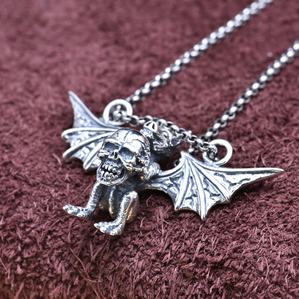 S925 sterling silver winged demon skull pendant on chain showing gothic bat wing detail and dark elegance symbolism