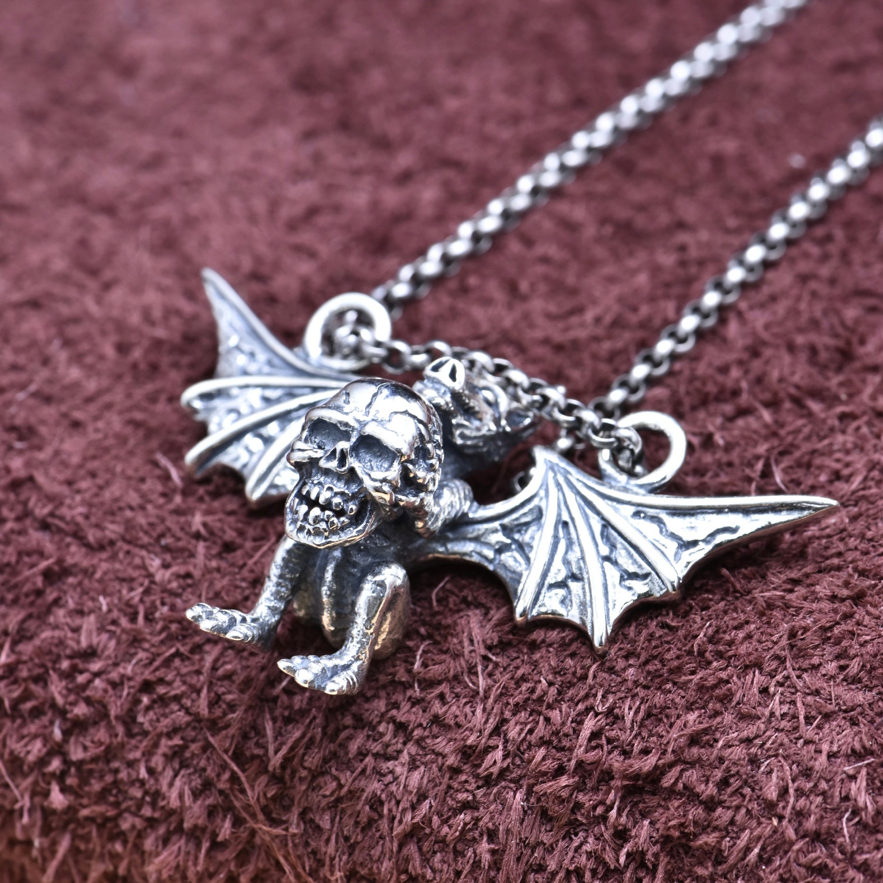 S925 sterling silver winged demon skull pendant on chain showing gothic bat wing detail and dark elegance symbolism