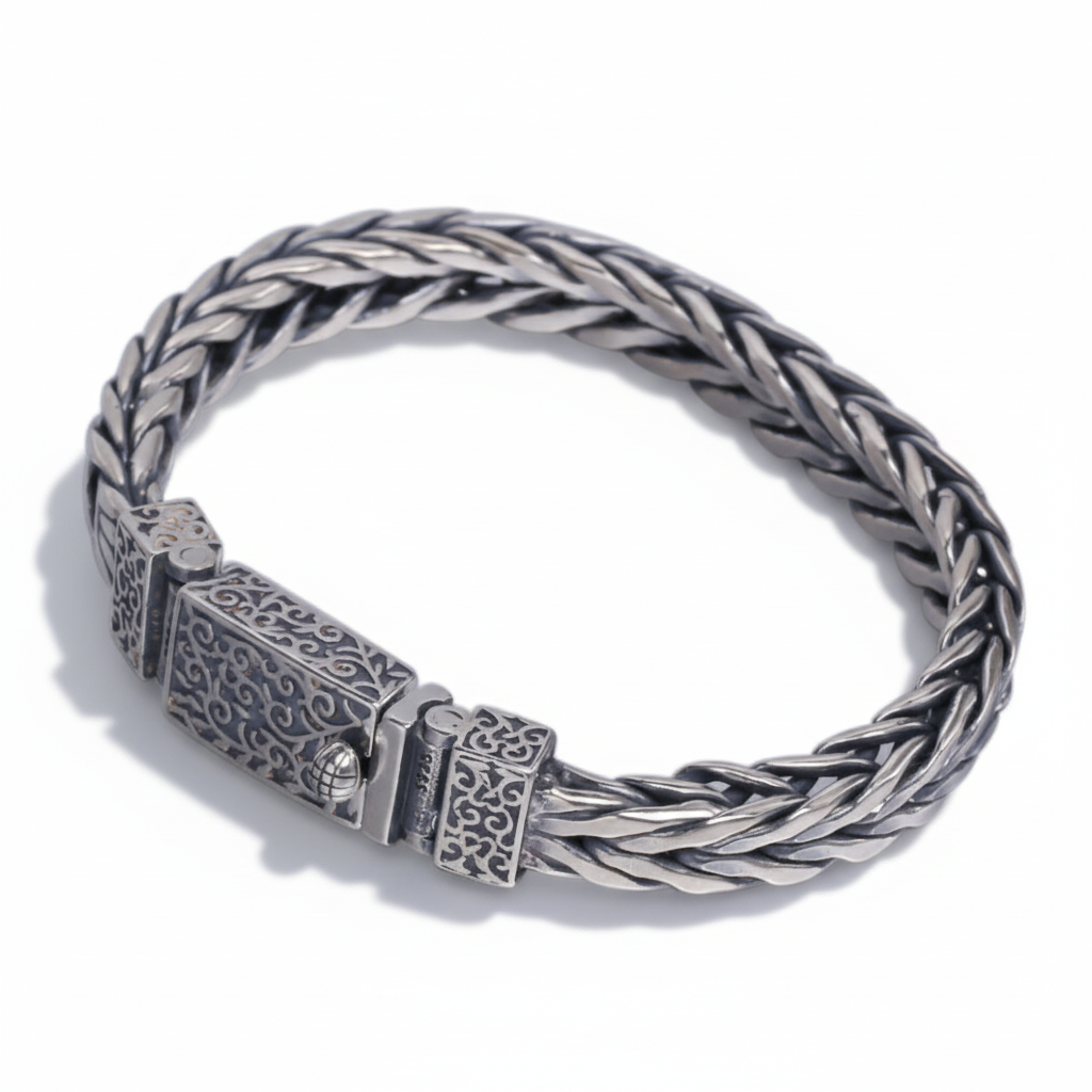 S925 sterling silver heavy wheat chain bracelet on white background showing thick wheat weave pattern with ornate engraved clasp, polished finish, and natural shadow