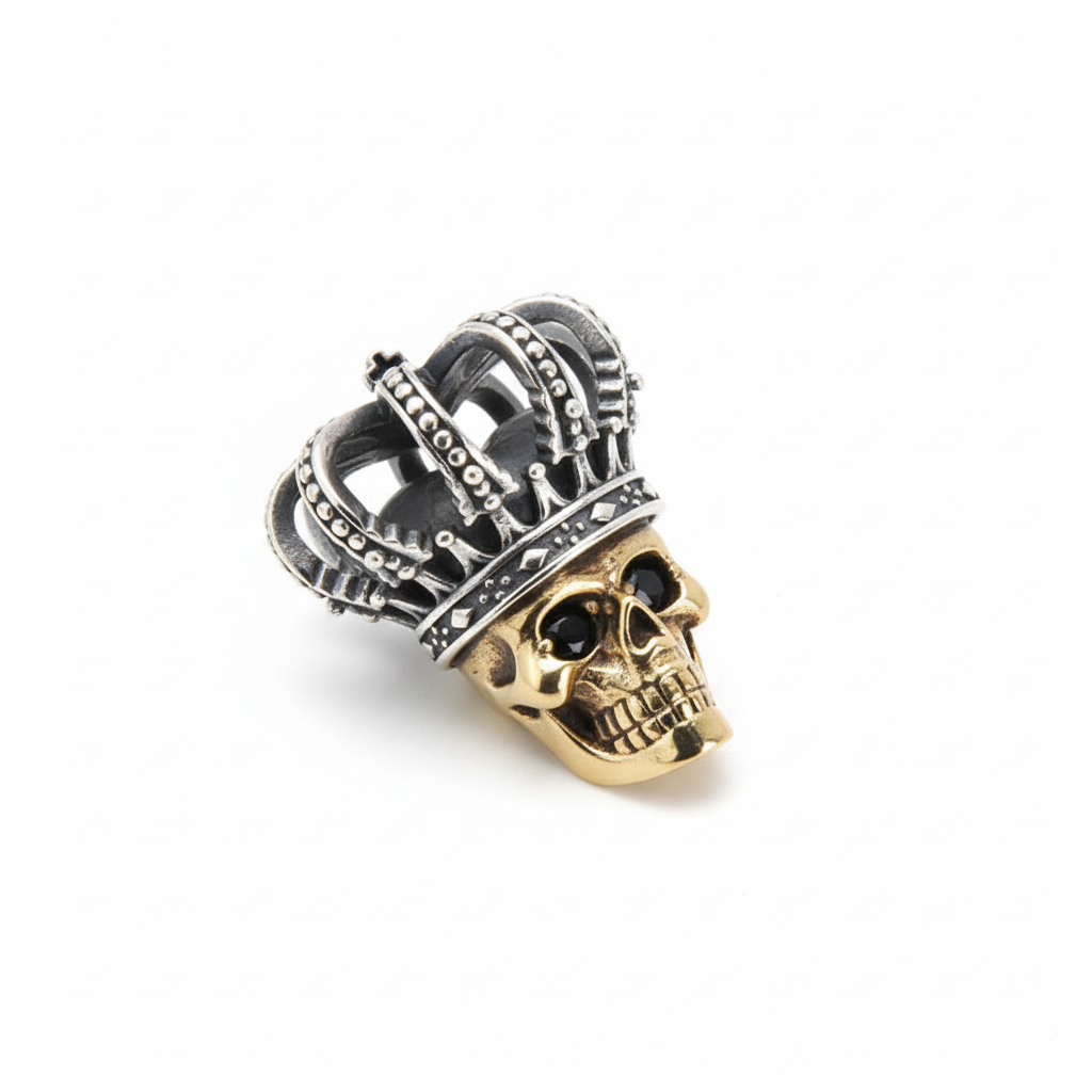S925 sterling silver crown skull pendant on white background showing detailed crowned skull with brass skull accent, oxidized Thai silver finish, and natural shadow