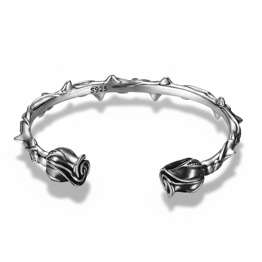 S925 sterling silver rose thorn bracelet on white background showing detailed rose end caps, thorned vine band, oxidized finish, and natural shadow